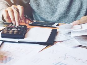 Man using calculator to calculate bills.