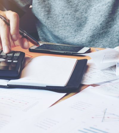 Man using calculator to calculate bills.